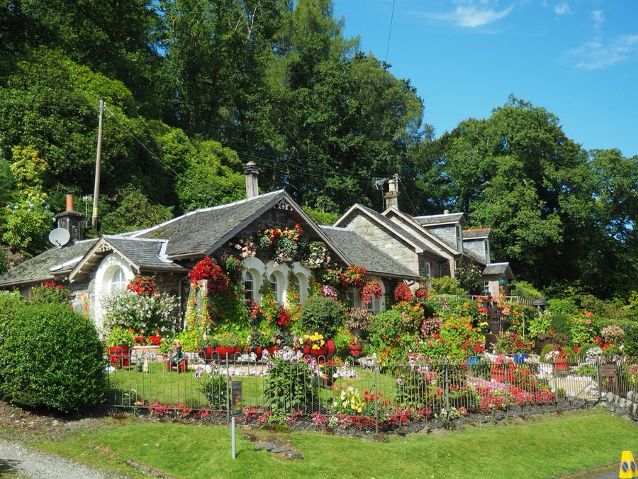 Home with a cut lawn and full flower beds